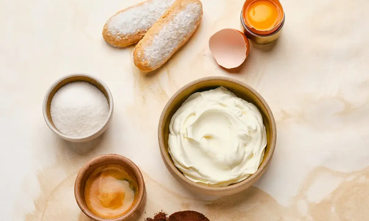 Ingrédients pour un tiramisu : boudoirs, sucre, café, cacao, œuf et un grand bol de mascarpone 500g.