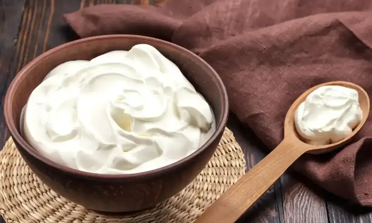 Crème diplomate mascarpone on a wooden table, ready to be used in a delicious dessert.