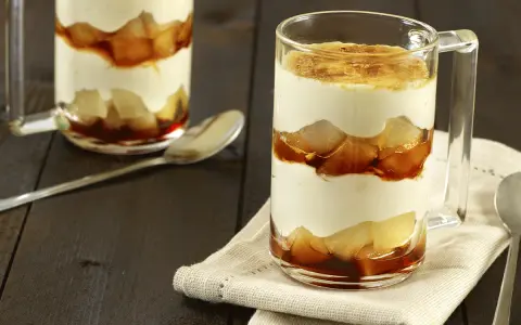 Un délicieux tiramisu poire, superposé en couches dans un verre, avec une touche caramélisée sur le dessus.