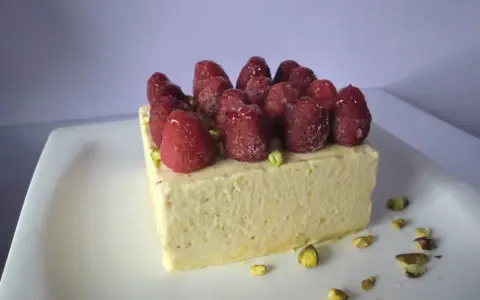 Gâteau rectangulaire pistache framboise mascarpone, garni de framboises fraîches et éclats de pistaches. Un délice !