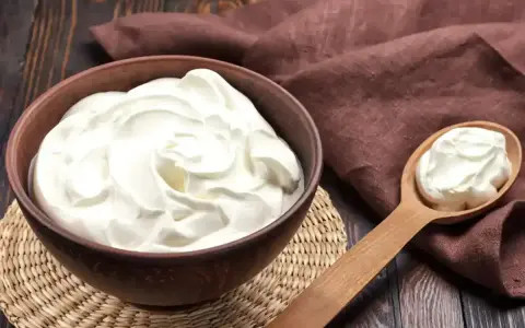 Crème diplomate mascarpone on a wooden table, ready to be used in a delicious dessert.