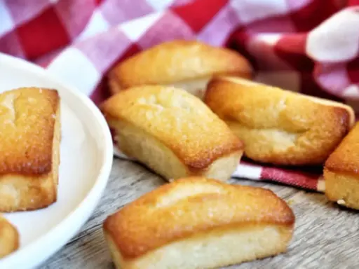 Financiers dorés sur une serviette à carreaux rouges. Parfait pour savoir que faire avec des blancs d'œufs.