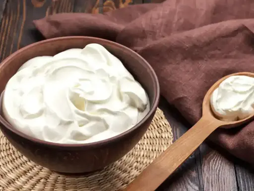 Crème diplomate mascarpone on a wooden table, ready to be used in a delicious dessert.
