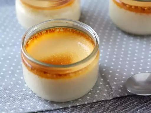 Crème aux œufs grand-mère dans des pots en verre, avec une belle croûte caramélisée. Un délice réconfortant.