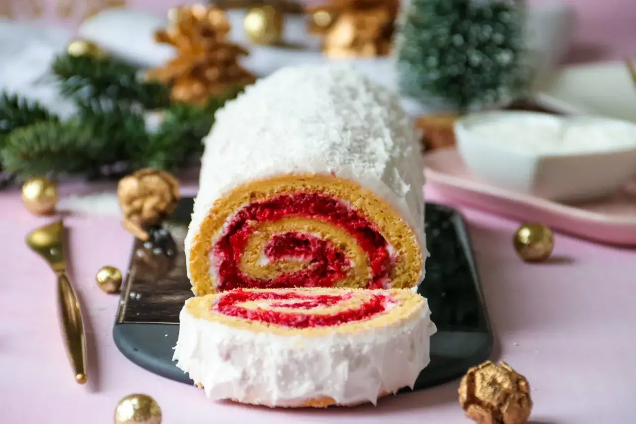 Une délicieuse bûche roulée à la framboise, recouverte de noix de coco râpée. Parfait pour apprendre comment rouler une bûche et impressionner vos invités.